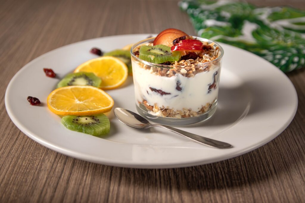 Bowl of yogurt topped with fruit. Many yogurts contain probiotics which support our gut microbiota.